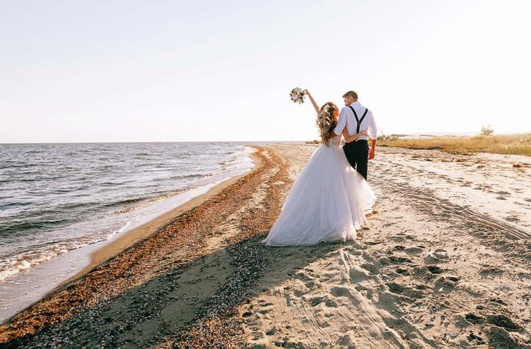 bride and groom on the seashore. wedding concept on the sea, on